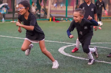 Jugadores jóvenes de fútbol chocando las manos en muestra de compañerismo